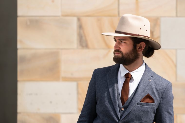 Beige men's hat with grey suit Beige men's hat with grey suit