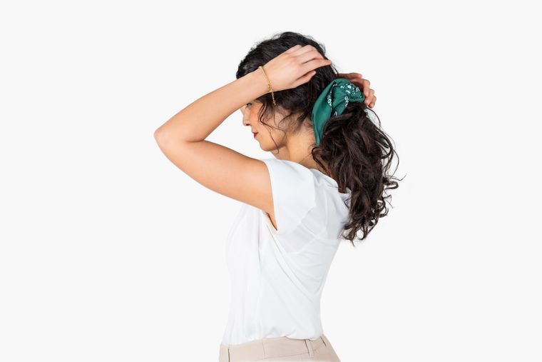 Tying the bandana into a hair tie Tying the bandana into a hair tie
